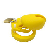 Vibrant yellow penis cage sissy for work and play, offering size adaptability with five rings. A playful alternative; great for bosses seeking discreet control shots!
